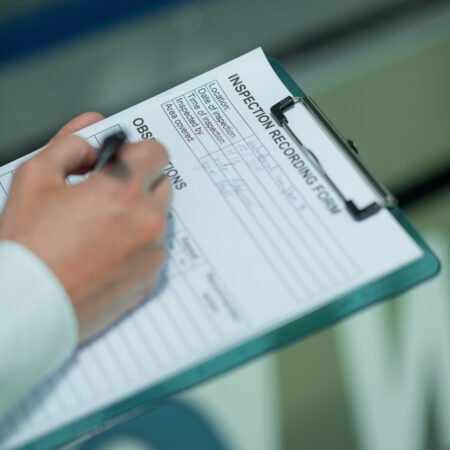 Technology Engineer Working in Factory. Holding check-list and supervising